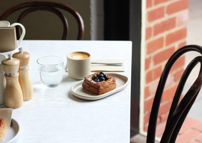 Catch up coffee and pastry at Waterfront Pantry Geelong on a table